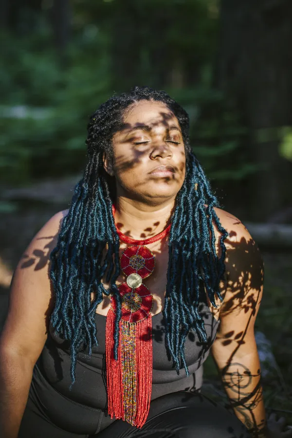 A person with their eyes closed in the sunlight